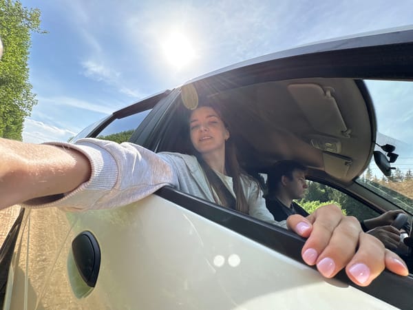 Woman photographed near white car in Siberian Russia morning