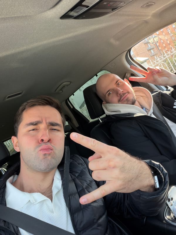 Two men photographed in playful moment inside car in Krasnoyarsk