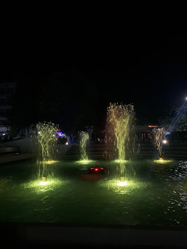 Popovo's city fountain glows through a colorful nighttime light show