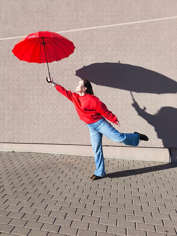Woman poses with CGI umbrella in Riga street scene