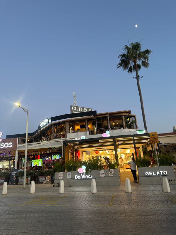 Peyia's main strip comes alive at dusk on a June evening