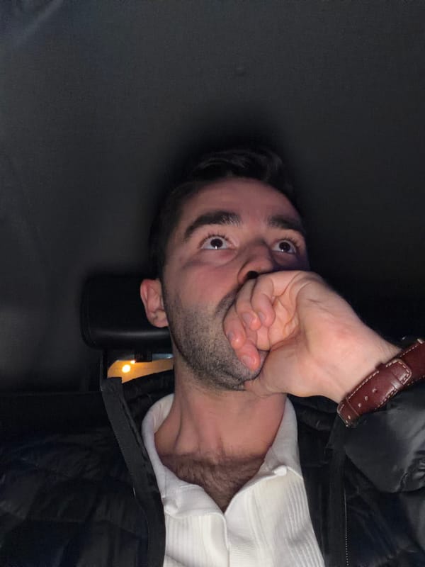 Man covers mouth with hand in Moscow street scene