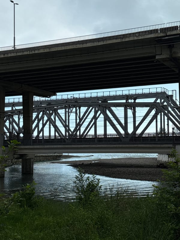 Urban waterway scene with bridges and solitary angler captured