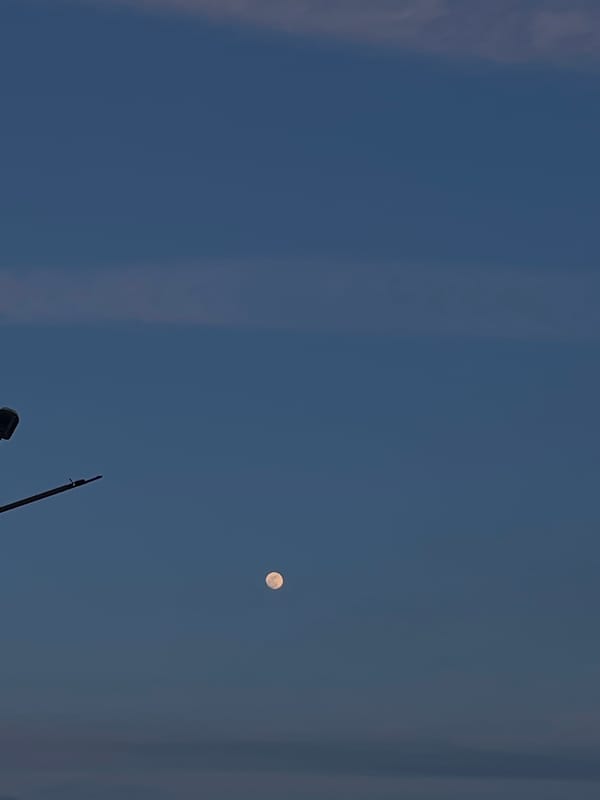 Full moon visible over Byala Slatina, Bulgaria evening sky