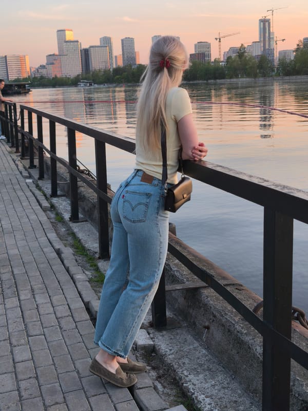 Woman enjoys sunset view from Moscow's Frunzenskaya Embankment