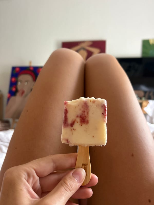 Person enjoys red-swirled popsicle in North Kuta residence