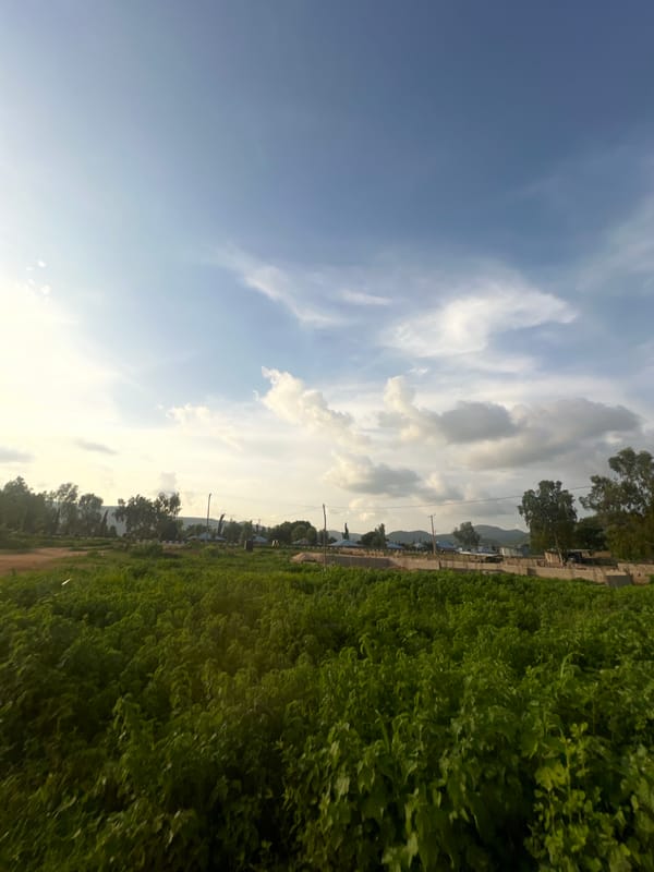 Rural road scenes across two Nigerian villages on a cloudy afternoon