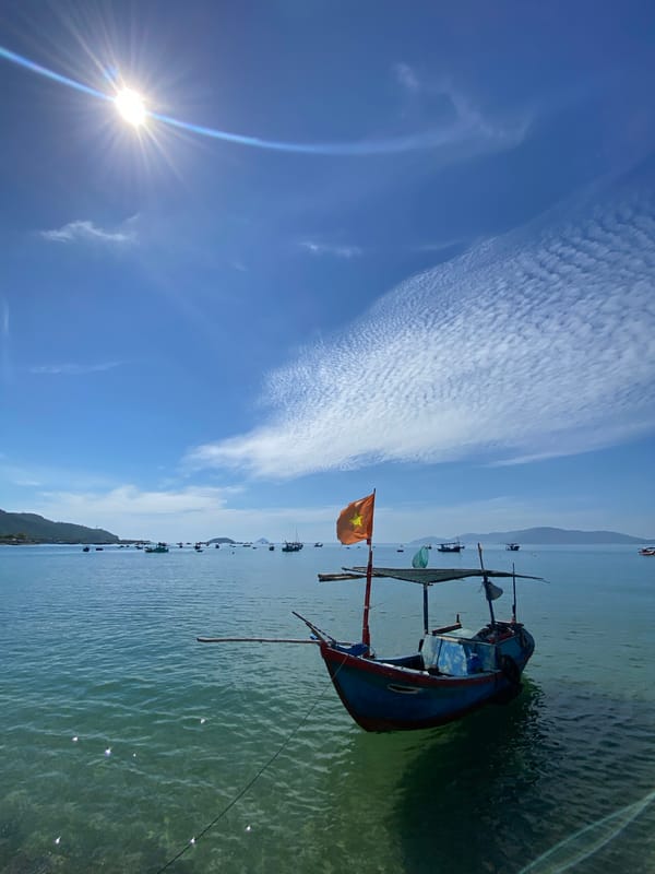 Blue fishing boat and calm bay views around Nha Trang's coast