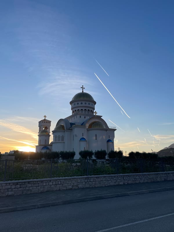 Evening scenes captured around Bar, Montenegro include church, dog, palms