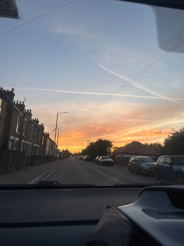 Sunset drive through Borough of Swale with contrails overhead