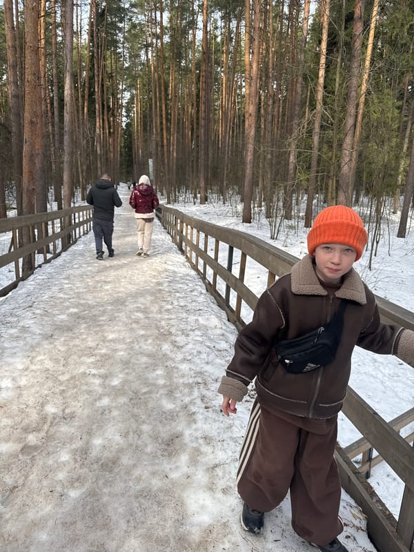Child explores snowy park in Votkinsk, Russia winter morning