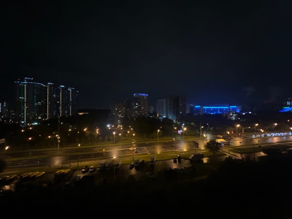 City at night: wet streets, glowing skyline, two angles