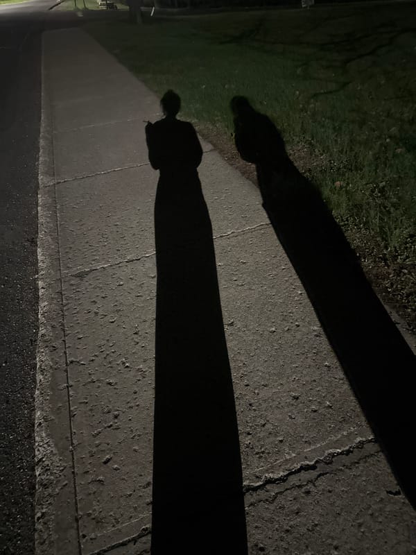 Late-night cigarette moment captured on Red Hook sidewalk