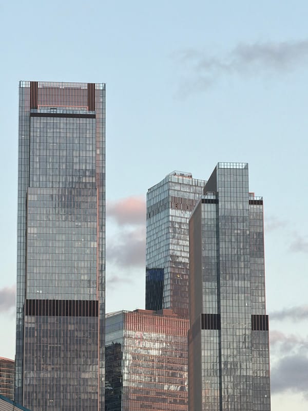 Moscow glass towers glow at sunset from street level