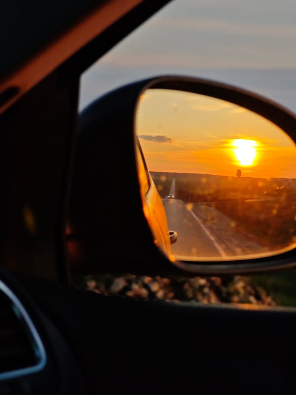 Sunset reflected in car mirror on Bulgarian road