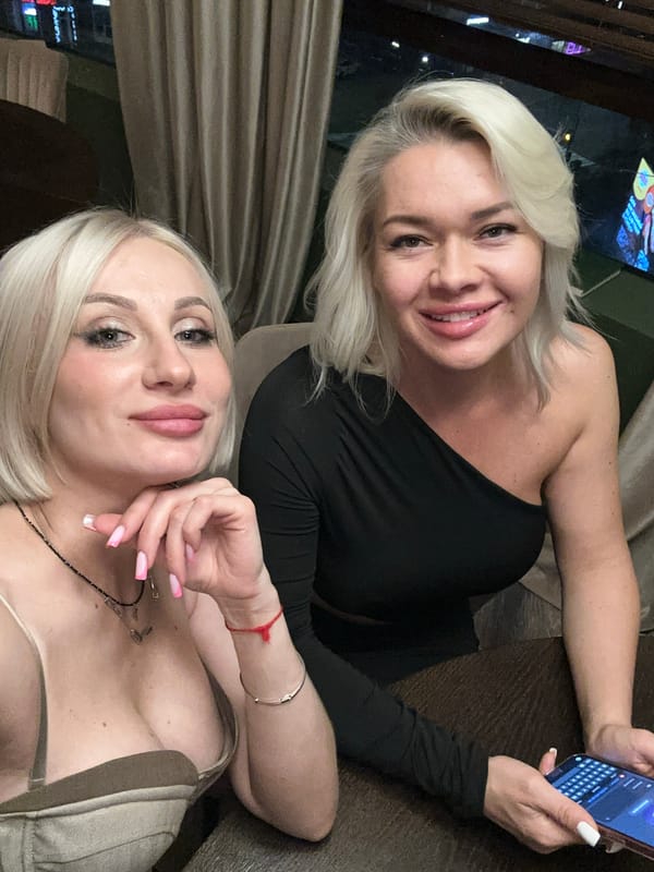 Two women pose for photos in Pushkino, Russia