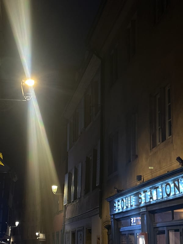 Evening documentation captures Seoul Station, stickered window, post-meal table