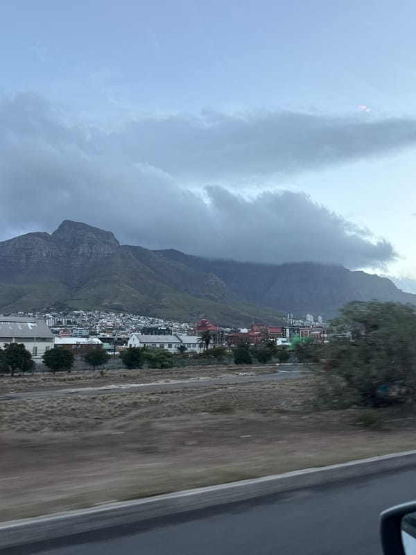 Table Mountain photographed through clouds from Cape Town vehicle