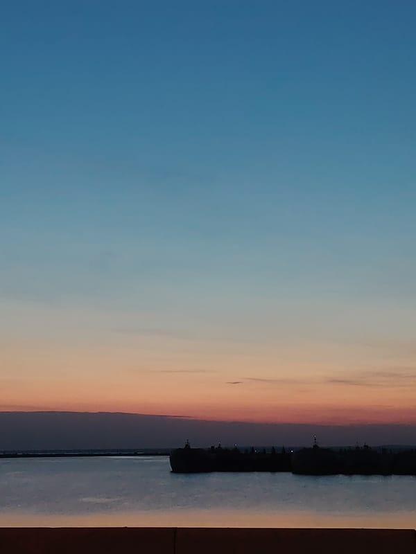 Dusk colors reflected in water observed in Chaikovsky, Russia
