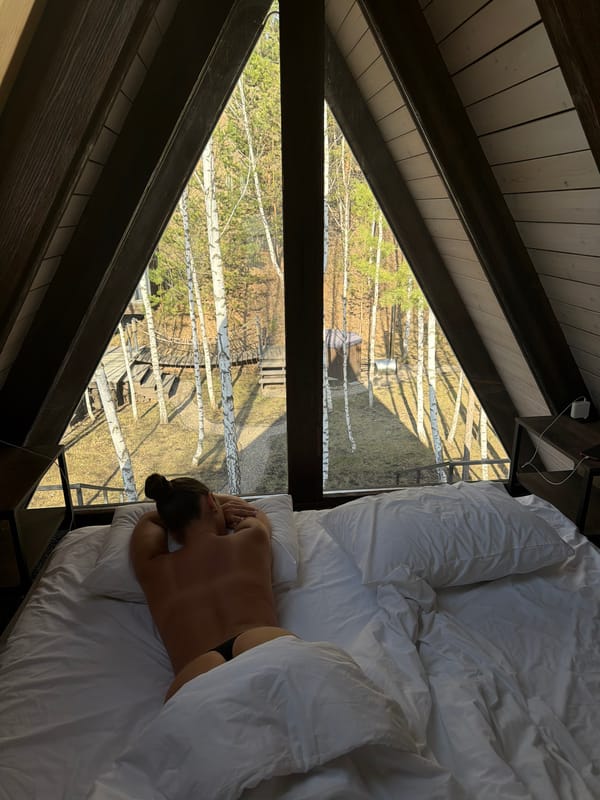 Person resting in bed captured from overhead view in Berezovka