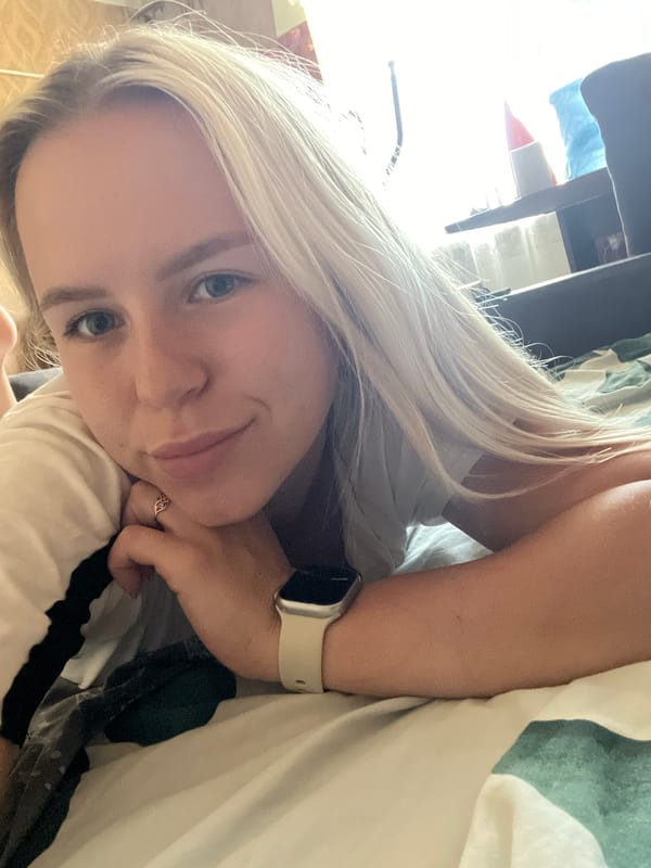 Casual bed selfies in a white tee with a smartwatch