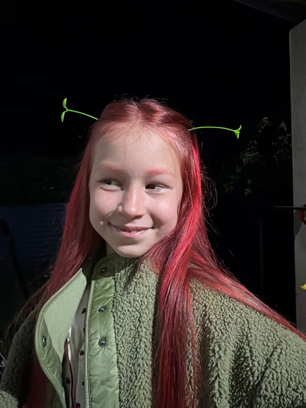 Red-haired person with plant sprouts photographed in Markovo, Russia