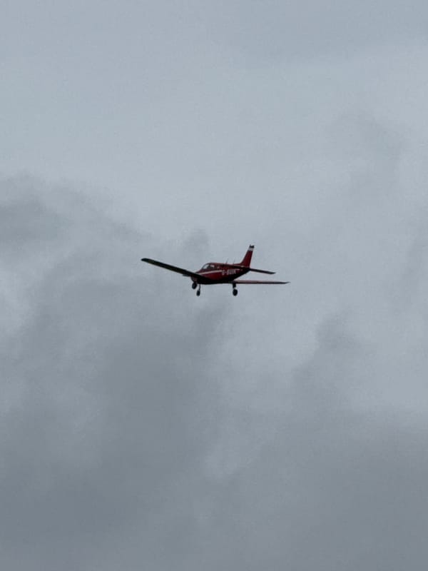 Biplane performs inverted flight over Epping Forest