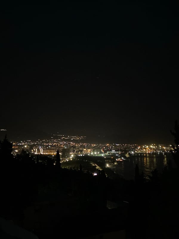 Evening lights illuminate Šušanj coastline in Montenegro