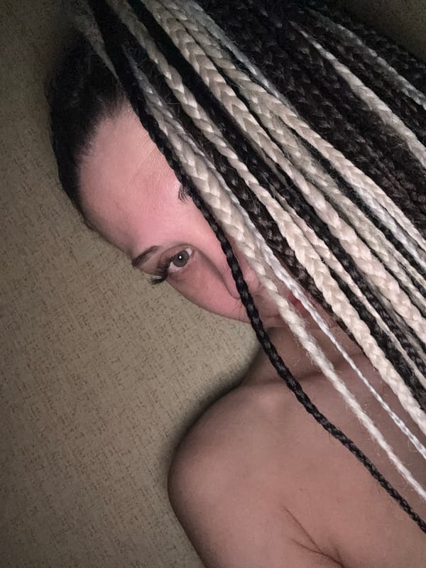 Person with braided hair photographed indoors in Rusanovo