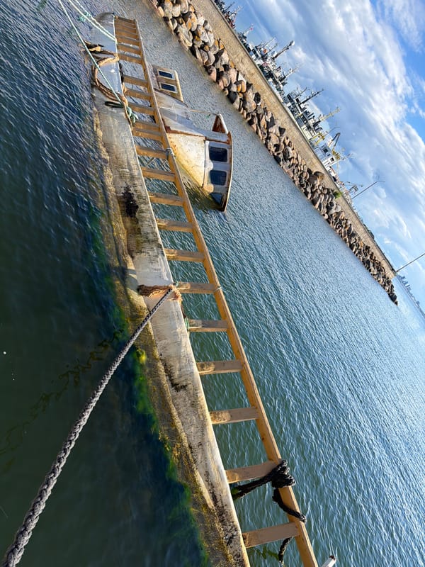 Sunken boat and harbor activity in Viimsi, Estonia