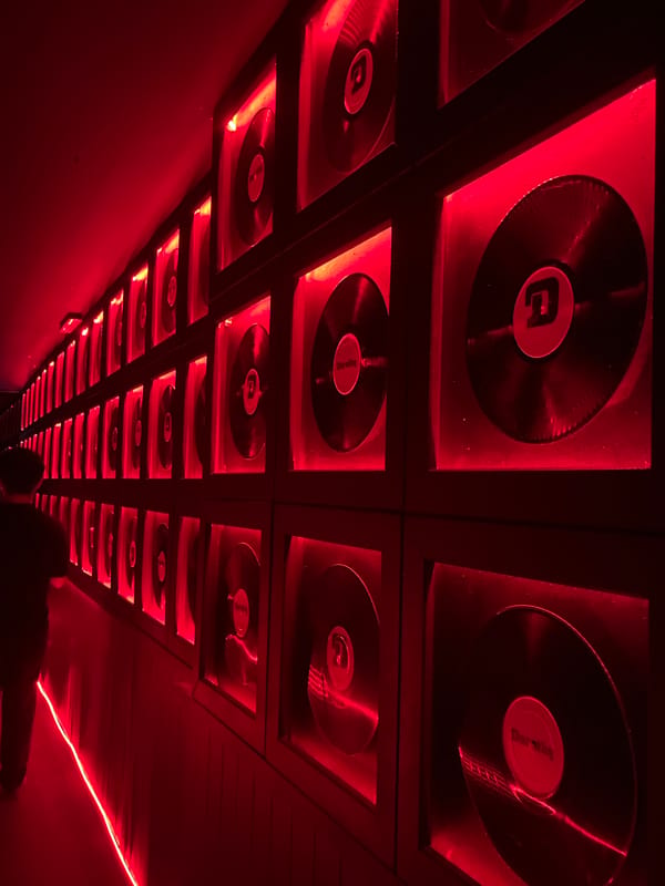 Illuminated vinyl record display documented in club-like venue