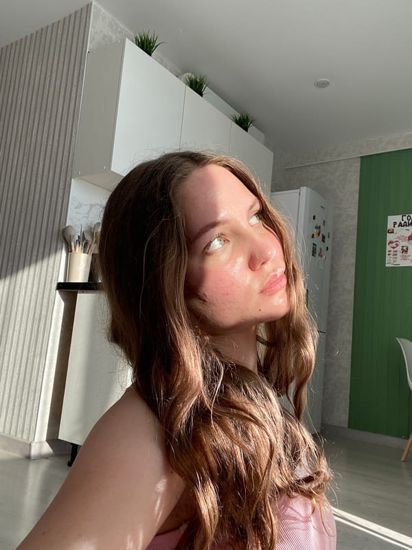 Woman takes selfies in afternoon sunlight in Izhevsk