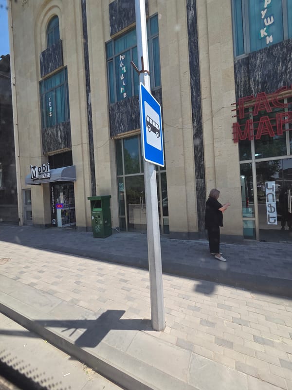 Sunny morning street scene outside a Gyumri storefront