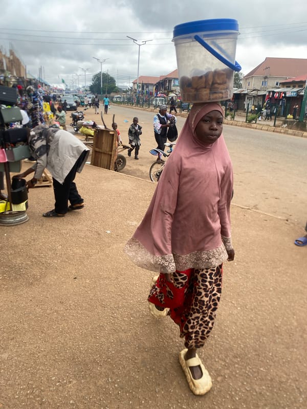 Morning street traffic and market activity in Bukuru, Nigeria