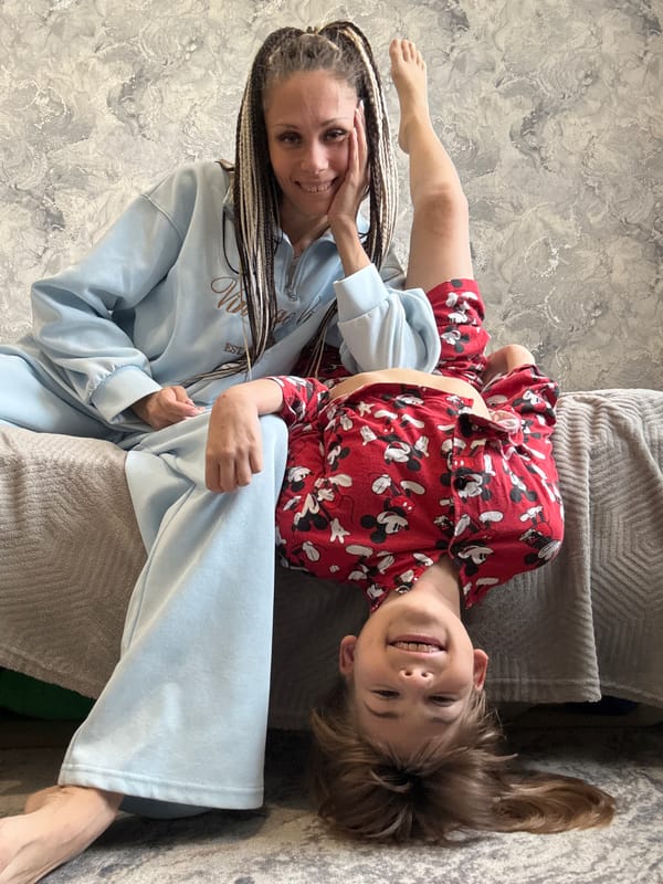 Mother and child photographed together on sofa in Rusanovo