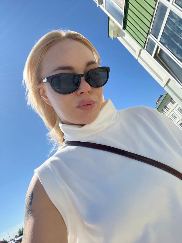 Sunny day selfie series outside a light blue building