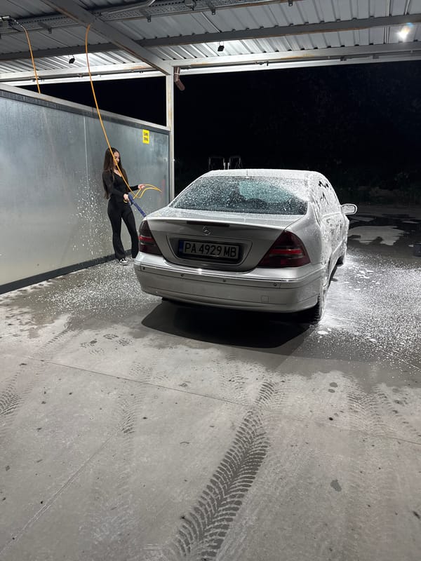 Woman washes silver Mercedes at car wash in Plovdiv