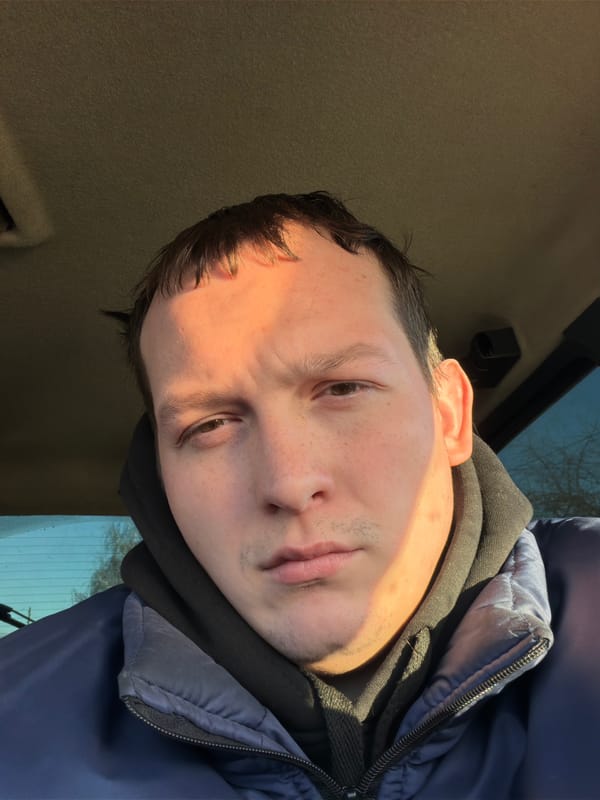 Person takes selfies in car during early morning hours