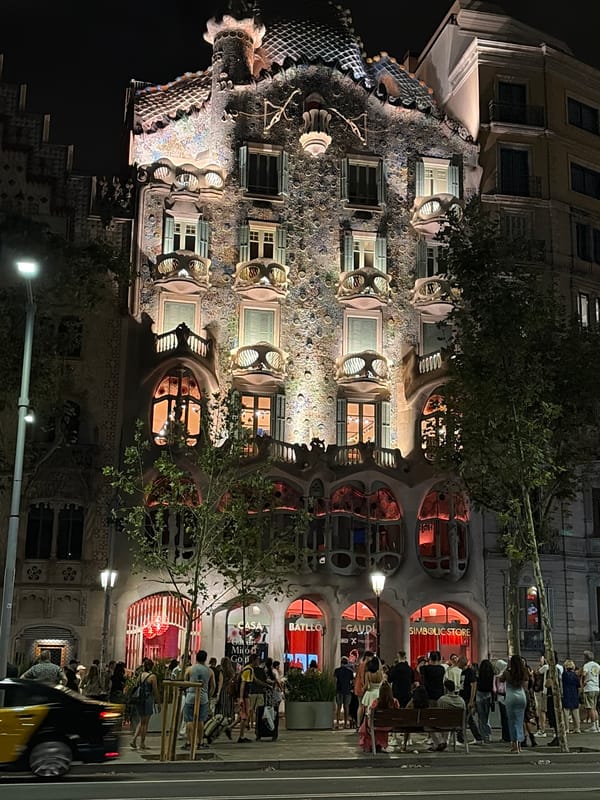 Casa Batlló's illuminated facade glowing on Passeig de Gràcia
