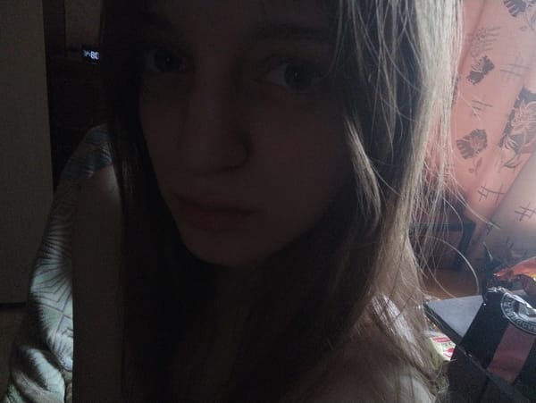 Woman takes indoor selfies with calico cat in Saratov