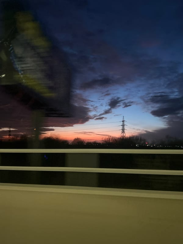 Sunset power lines photographed through blinds in Burgas