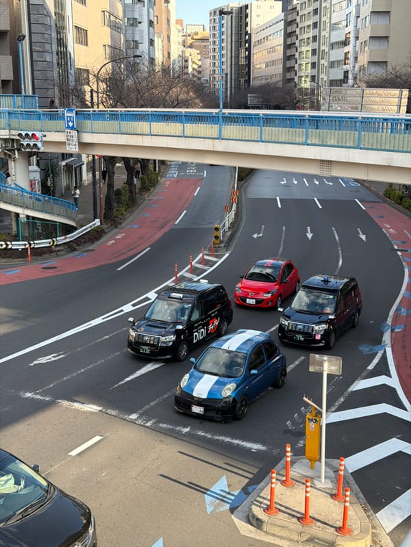 Morning traffic flows past graffitied overpass in Shibuya