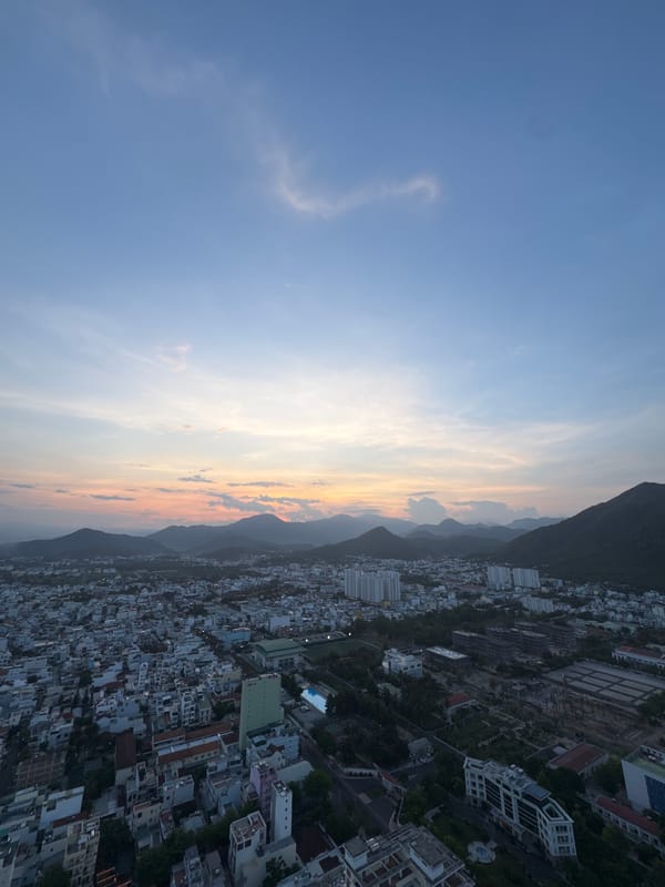 Aerial sunset views of coastal mountain city