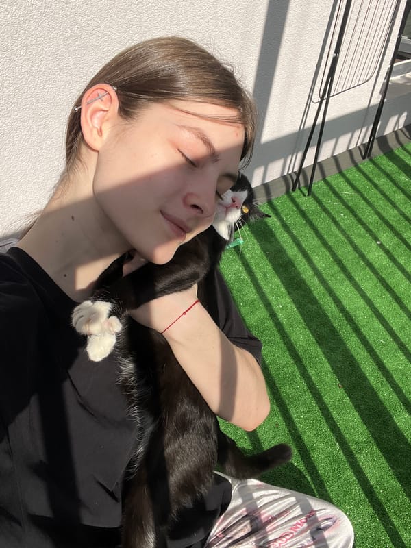 Woman relaxes with cat on Saint Petersburg balcony