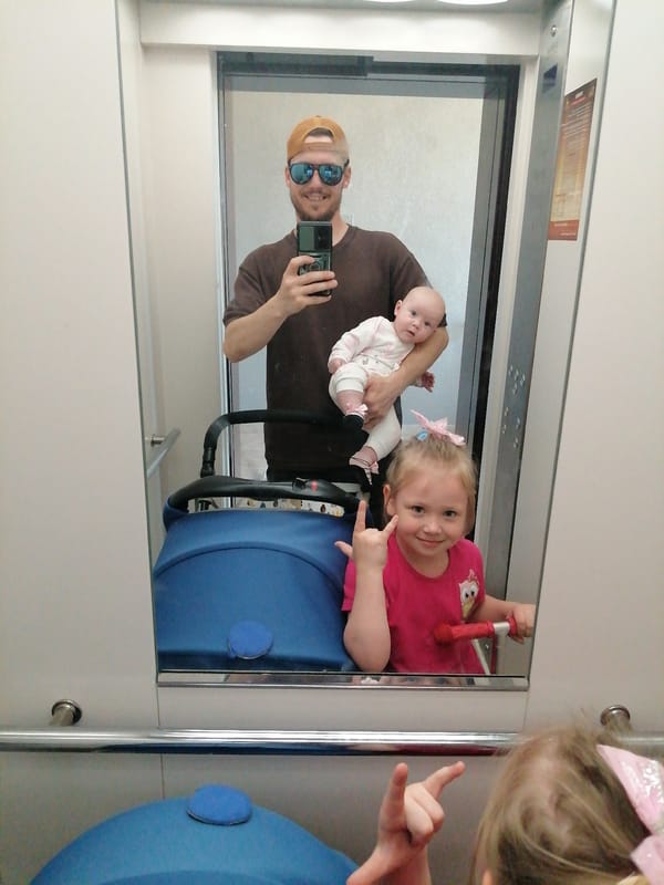 Rock-and-roll pose in an elevator selfie