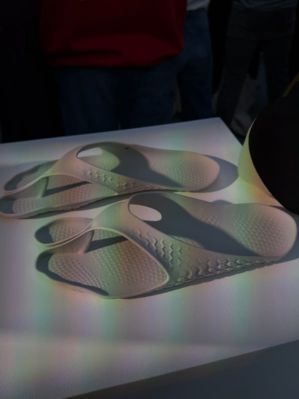 London gallery visitor documents sandals, art viewing captured simultaneously