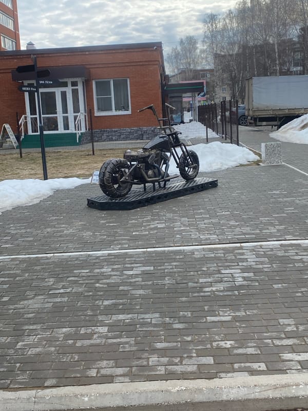 Trike motorcycle parked on sidewalk in Chaikovsky, Russia