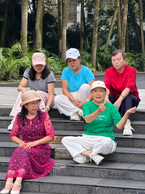 Women perform synchronized movements on steps in Jiulongpo District
