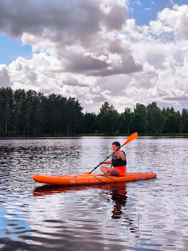 Stand-up paddleboarding on a quiet Latvian lake
