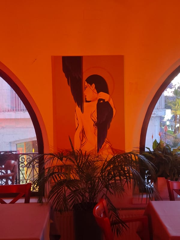 Restaurant interior with artwork and harbor views documented